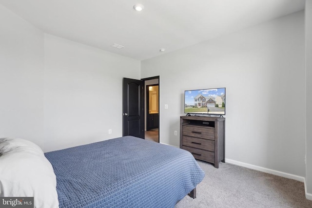 bedroom with light colored carpet and baseboards