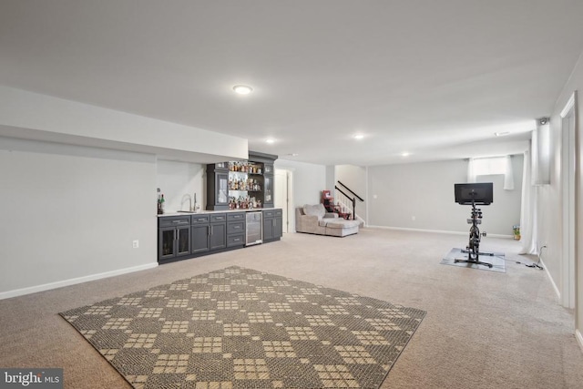workout room with light colored carpet, wet bar, baseboards, and beverage cooler