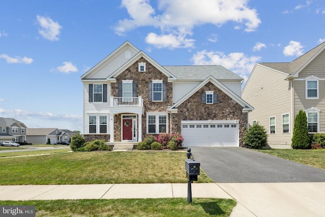 view of front facade featuring stone siding, a garage, driveway, and a front yard