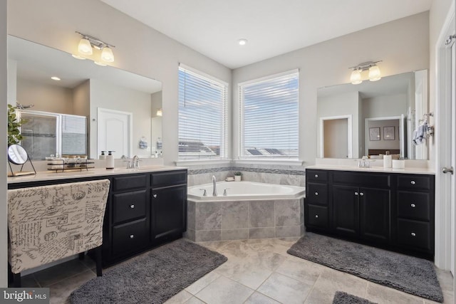 bathroom with a sink, a stall shower, two vanities, and a garden tub