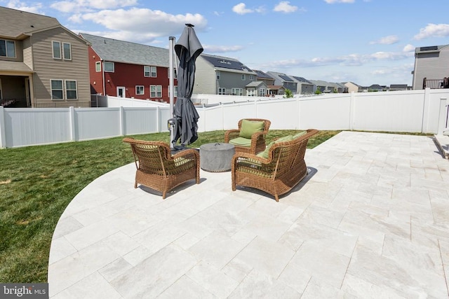 view of patio with an outdoor living space, a residential view, and a fenced backyard