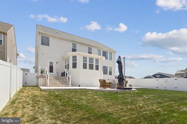 rear view of property with a gate, a patio area, a fenced backyard, and a yard