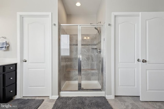 bathroom featuring a shower stall, tile patterned flooring, vanity, and recessed lighting