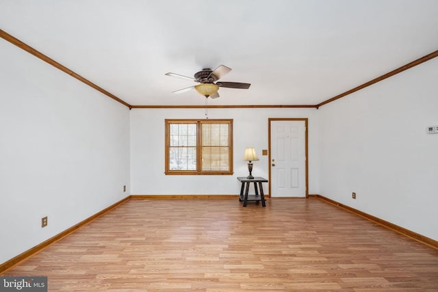 unfurnished room with light wood-type flooring, baseboards, a ceiling fan, and crown molding