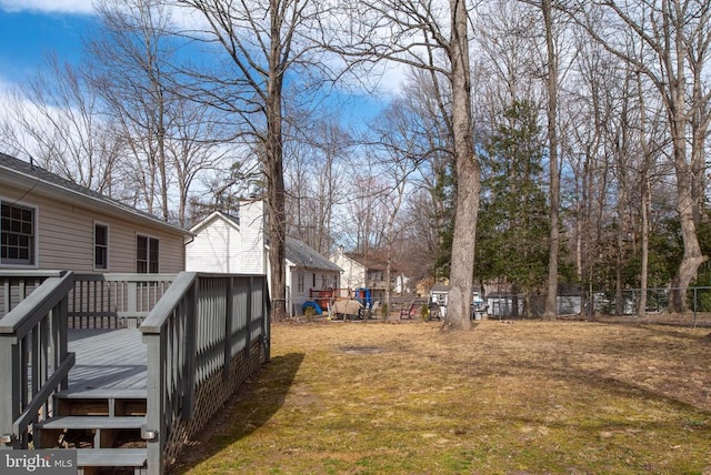 view of yard featuring a wooden deck and fence