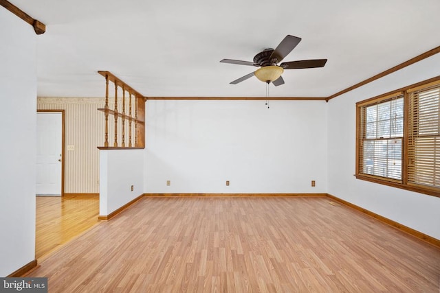 unfurnished living room featuring ceiling fan, baseboards, light wood-style floors, and ornamental molding