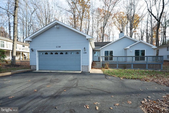 view of front of home featuring a garage and a deck