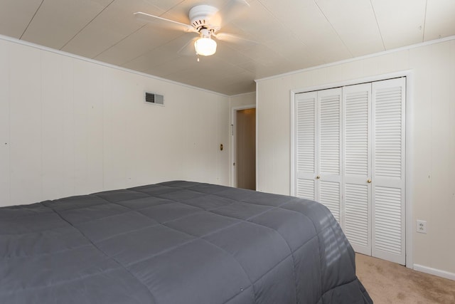 bedroom with a closet, ceiling fan, and carpet