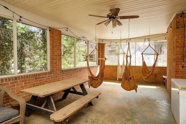 sunroom featuring ceiling fan