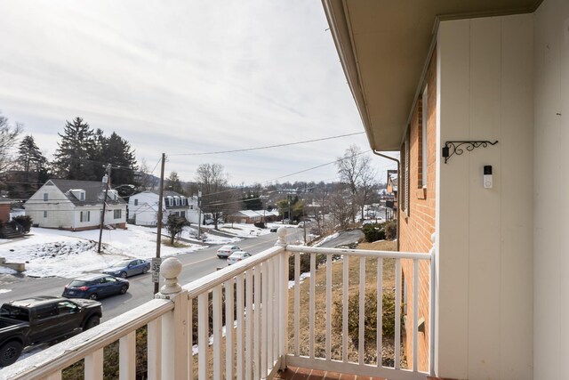 view of snow covered back of property