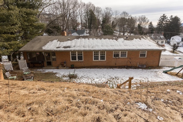 view of snow covered back of property