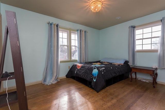 bedroom featuring wood-type flooring and multiple windows