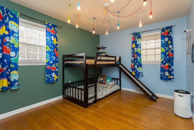 bedroom featuring multiple windows and wood-type flooring