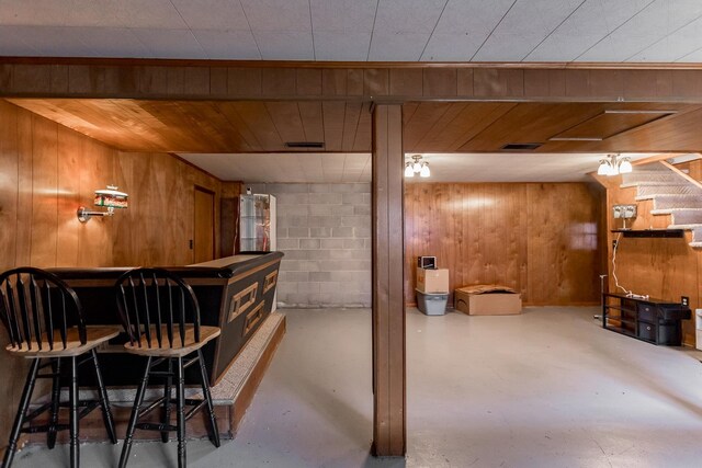 bar with concrete floors and wood walls