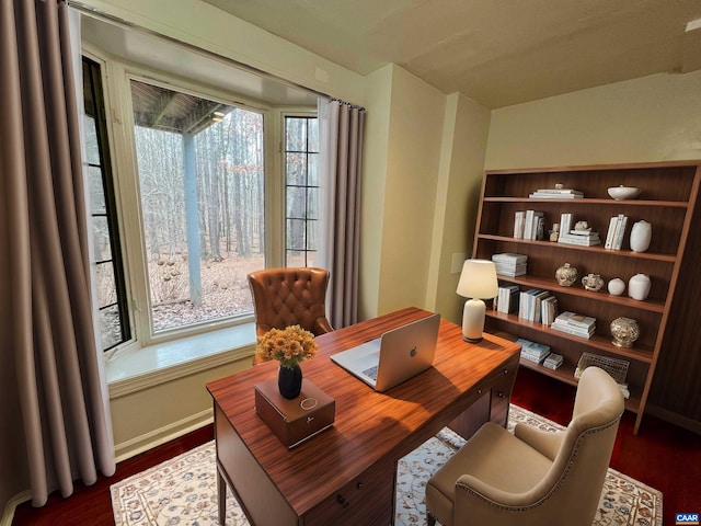 living area with baseboards and dark wood-type flooring