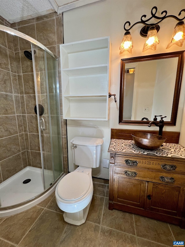 full bath with toilet, a shower stall, vanity, and tile patterned floors