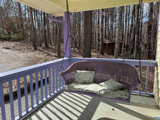 wooden deck with an outbuilding and a shed