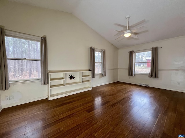 unfurnished living room featuring lofted ceiling, ceiling fan, visible vents, and dark wood finished floors