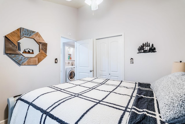 bedroom with a high ceiling, washer / dryer, and a closet