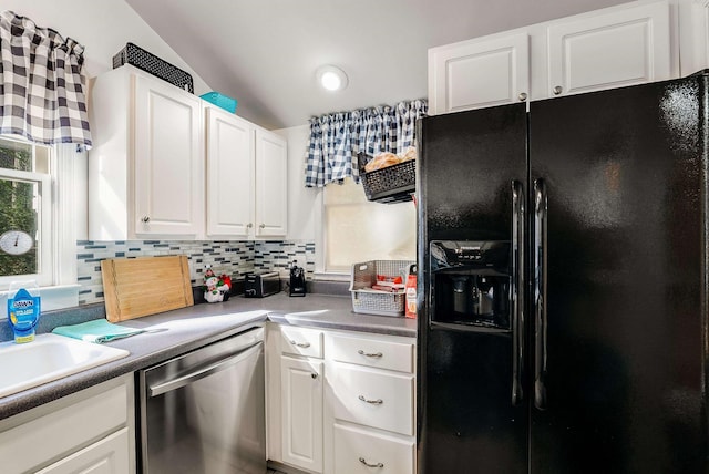 kitchen featuring white cabinetry, tasteful backsplash, dishwasher, and black fridge