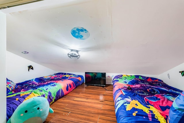 bedroom featuring hardwood / wood-style floors and vaulted ceiling