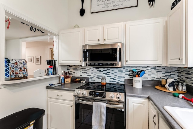 kitchen featuring white cabinetry, appliances with stainless steel finishes, sink, and backsplash