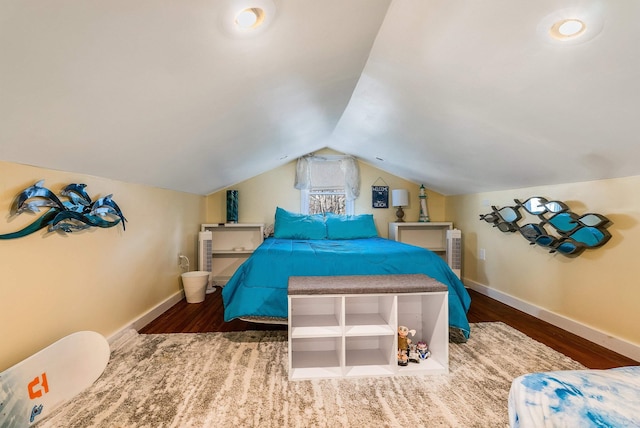 bedroom featuring lofted ceiling and dark hardwood / wood-style flooring