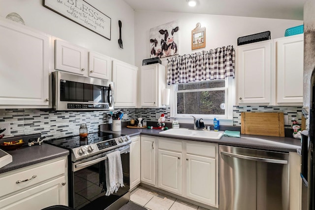 kitchen featuring backsplash, stainless steel appliances, sink, and white cabinets