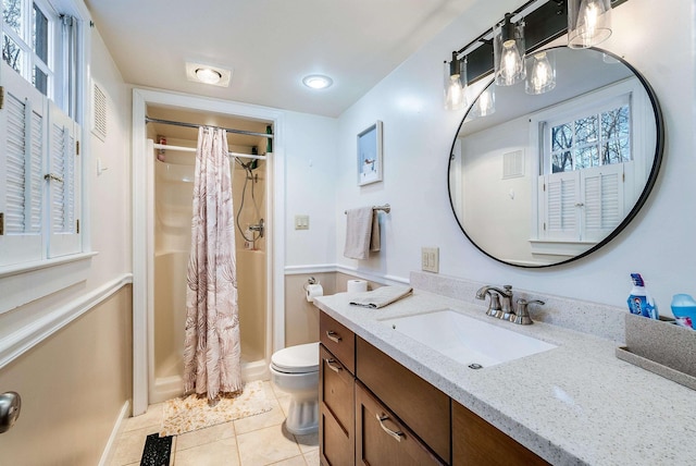 bathroom with vanity, toilet, curtained shower, and tile patterned flooring