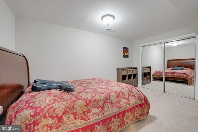 bedroom featuring a closet, carpet flooring, and visible vents