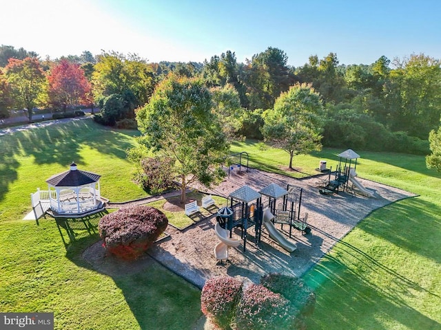 exterior space with a lawn, a playground, and a gazebo