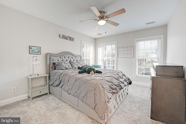 bedroom with carpet floors, a ceiling fan, visible vents, and baseboards