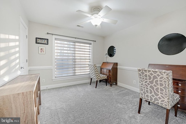 carpeted home office featuring visible vents, ceiling fan, and baseboards