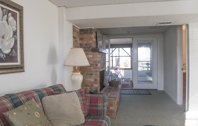 carpeted living room featuring a fireplace