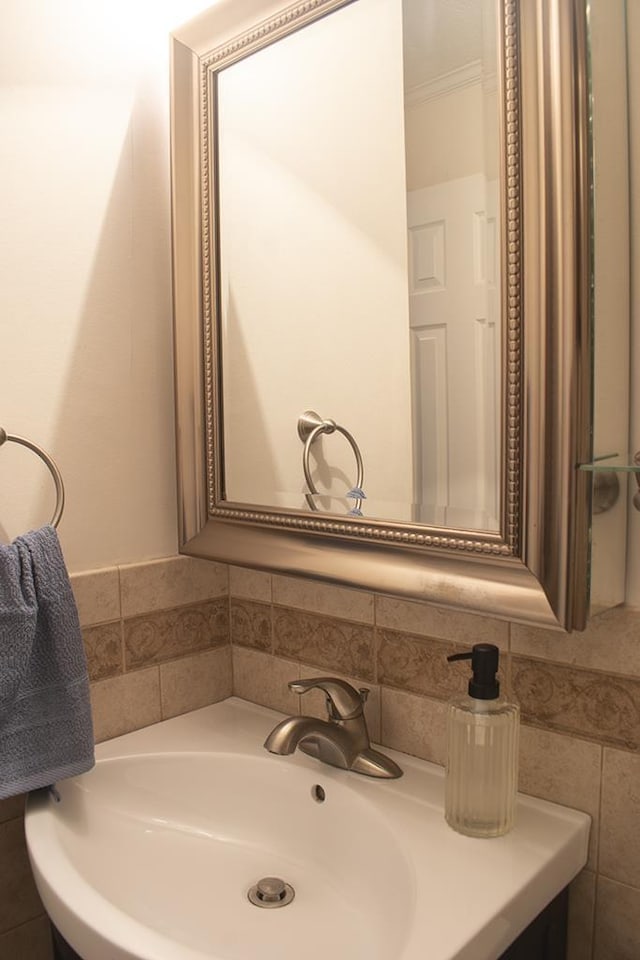 bathroom featuring crown molding and sink