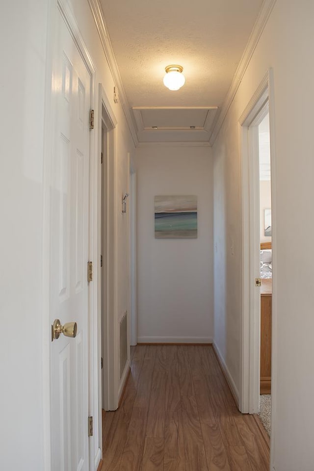 hall featuring ornamental molding and dark hardwood / wood-style flooring