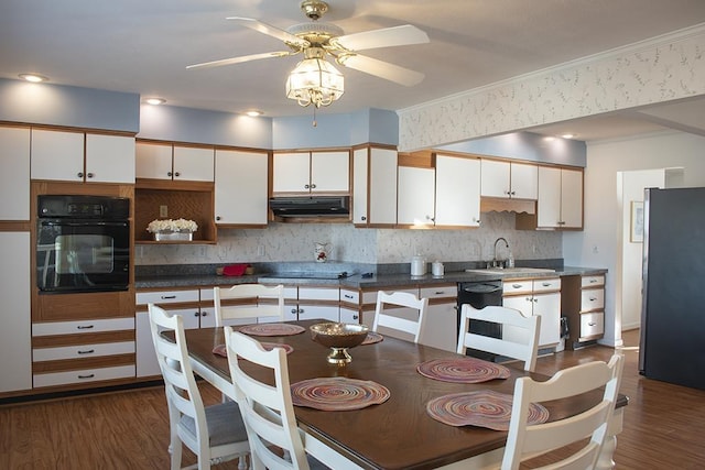 kitchen with white cabinetry, dark hardwood / wood-style flooring, sink, and black appliances