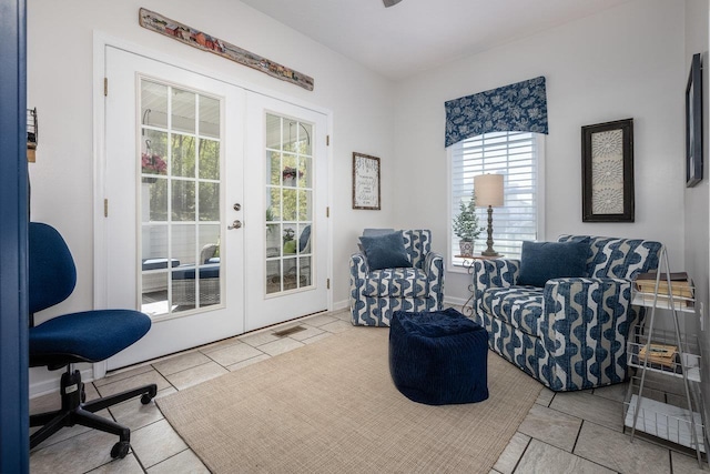 living area featuring french doors, tile patterned floors, and visible vents