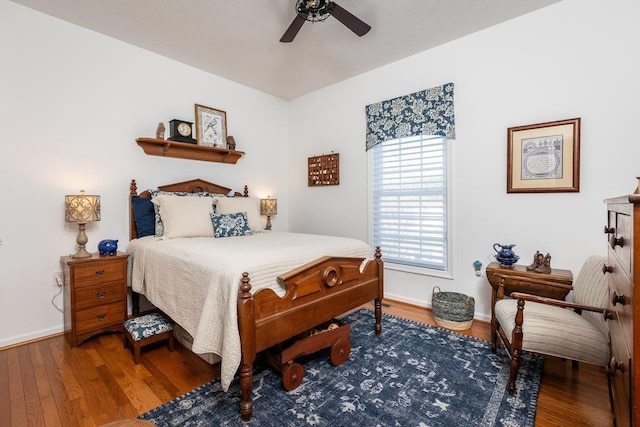 bedroom with baseboards, a ceiling fan, and wood finished floors
