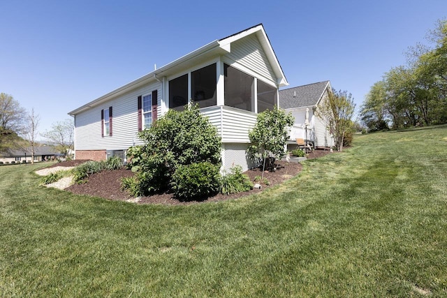 view of property exterior featuring a lawn and a sunroom