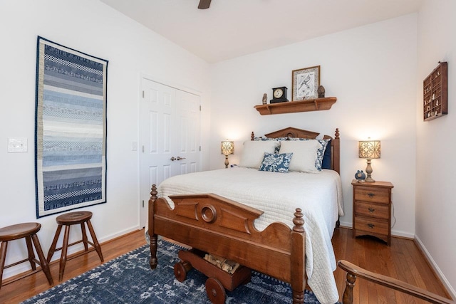 bedroom with baseboards, ceiling fan, and wood finished floors