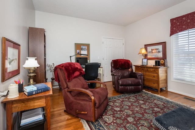sitting room with visible vents and wood finished floors