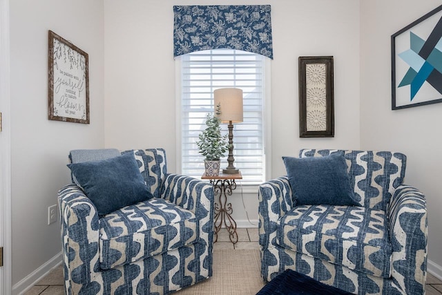 sitting room with plenty of natural light and baseboards