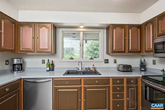 kitchen with light countertops, stainless steel appliances, and a sink