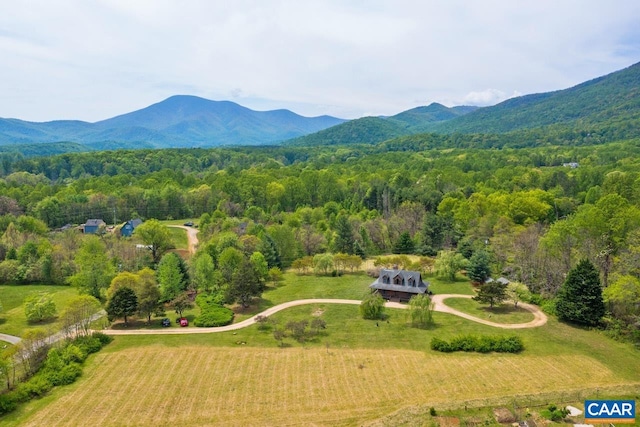 bird's eye view featuring a mountain view, a rural view, and a wooded view