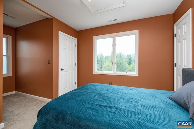 bedroom featuring carpet flooring, baseboards, visible vents, and attic access
