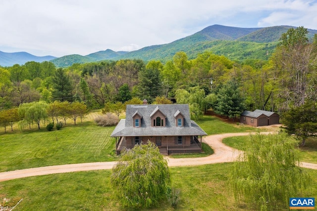 exterior space featuring a mountain view and a wooded view