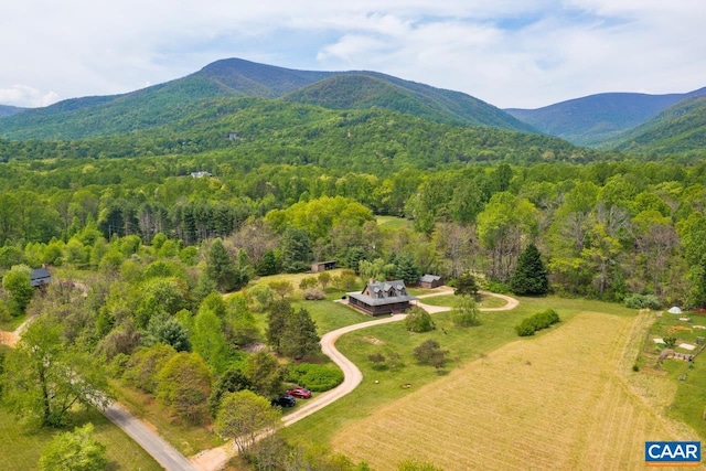 drone / aerial view with a wooded view and a mountain view