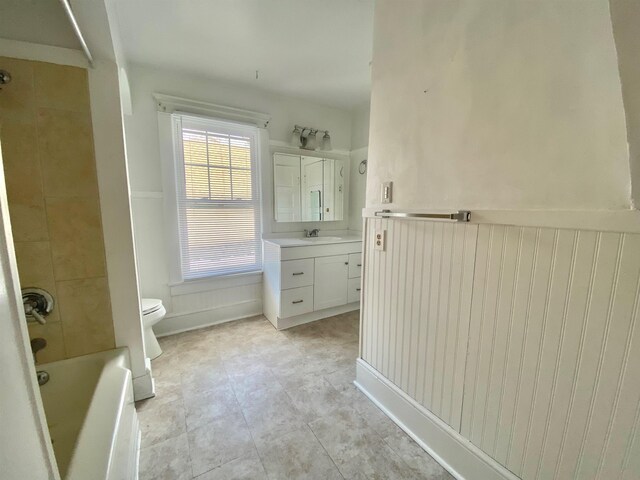 bathroom featuring shower / bathtub combination, vanity, and toilet