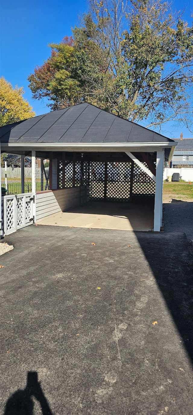 view of parking / parking lot featuring fence